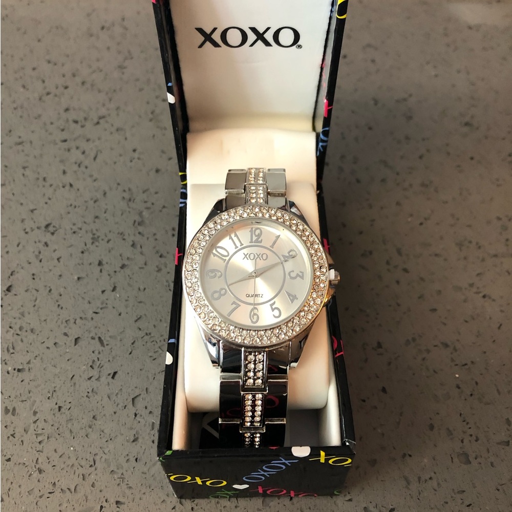 New XOXO silver watch for ladies. Never worn. Still attached in original box.